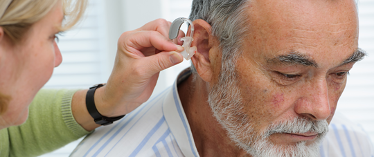 Patient Being Fitted with Hearing Aid